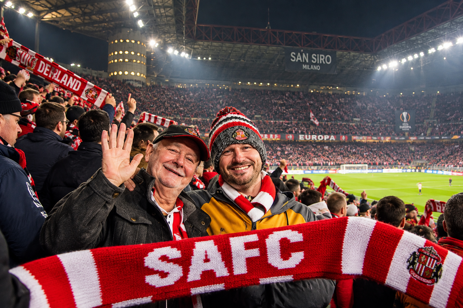 A father and son in Sunderland scarves and hats smiling in the away end at the San Siro in Milan, holding a red and white SAFC scarf